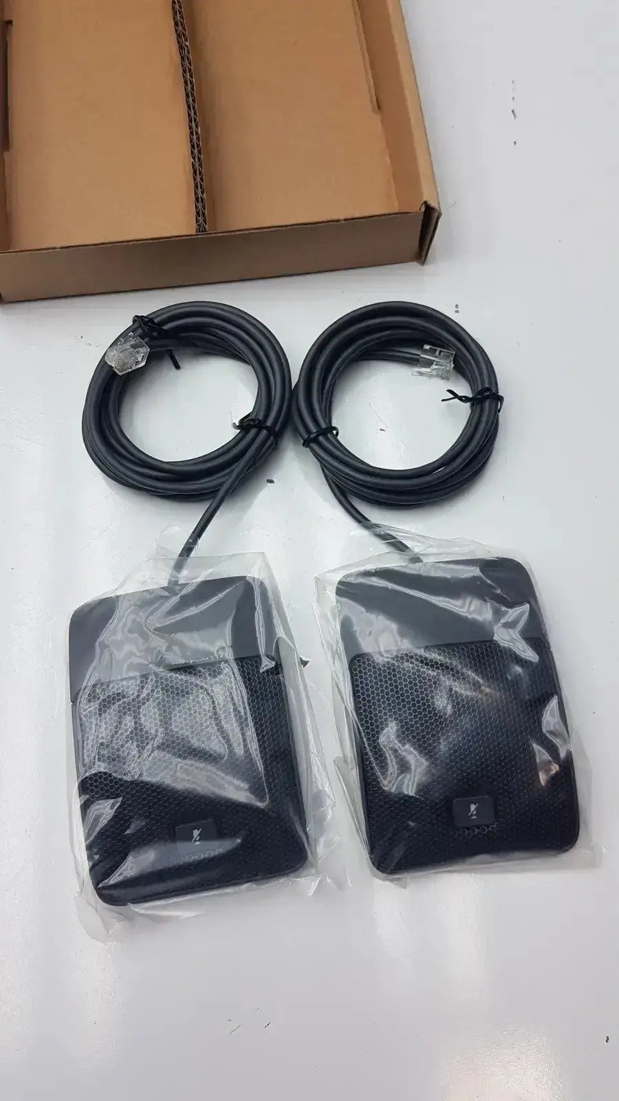 Set of 2 black rectangular Cisco UC phone conference phone microphones in clear plastic packaging for hospital surplus use