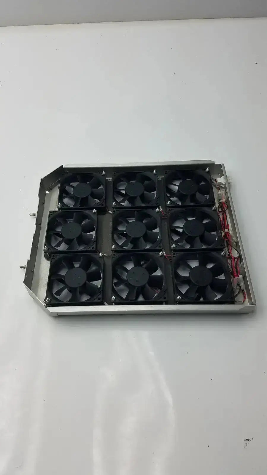 Set of 9 black brushless fan units mounted in a silver metal fan tray tray model afb0924vh