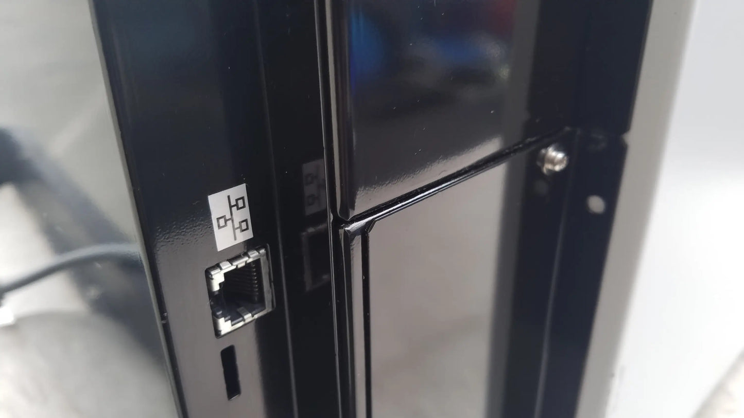 Black plastic ethernet port with white label on back side of shimadzu mce-202 multina microchip electrophoresis medical equipment