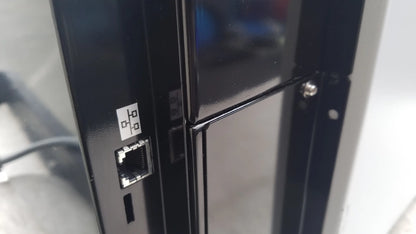 Black plastic ethernet port with white label on back side of shimadzu mce-202 multina microchip electrophoresis medical equipment