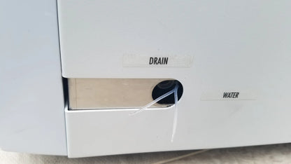 White plastic drain and water access panel with labeled openings on the back of shimadzu mce-202 multina microchip electrophoresis medical equipment