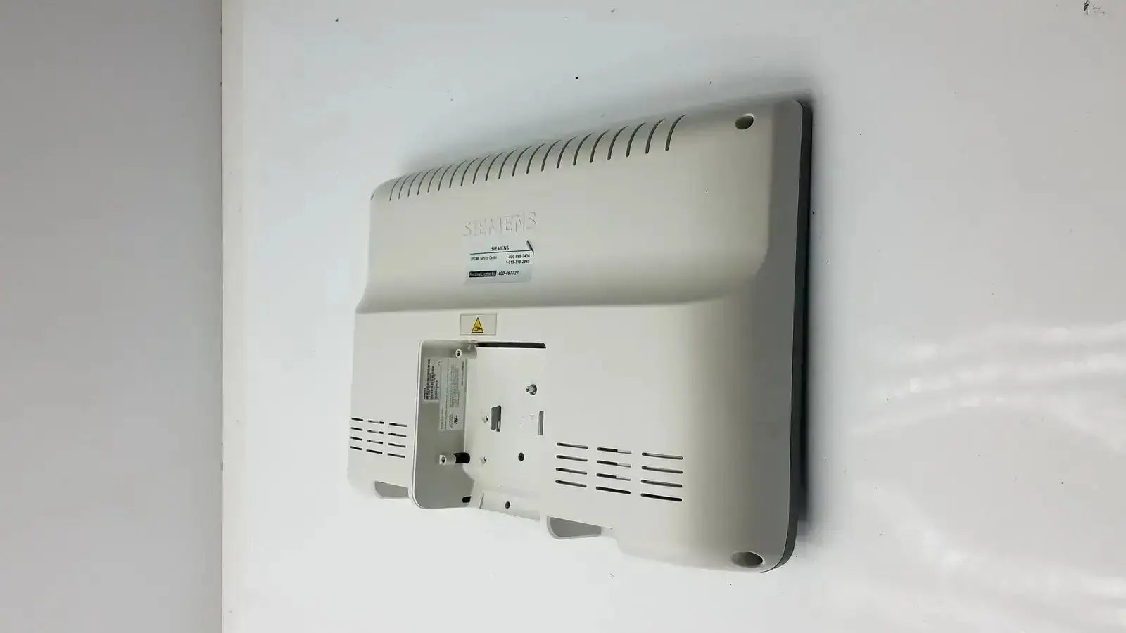 White plastic back panel of Siemens kt-lm215fds fhd flat panel display monitor with ventilation slits and mounting hardware