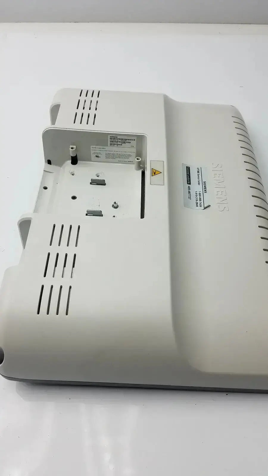 White plastic siemens kt-lm215fds fhd flat panel display monitor with ventilation slits and labeled stickers on the back side