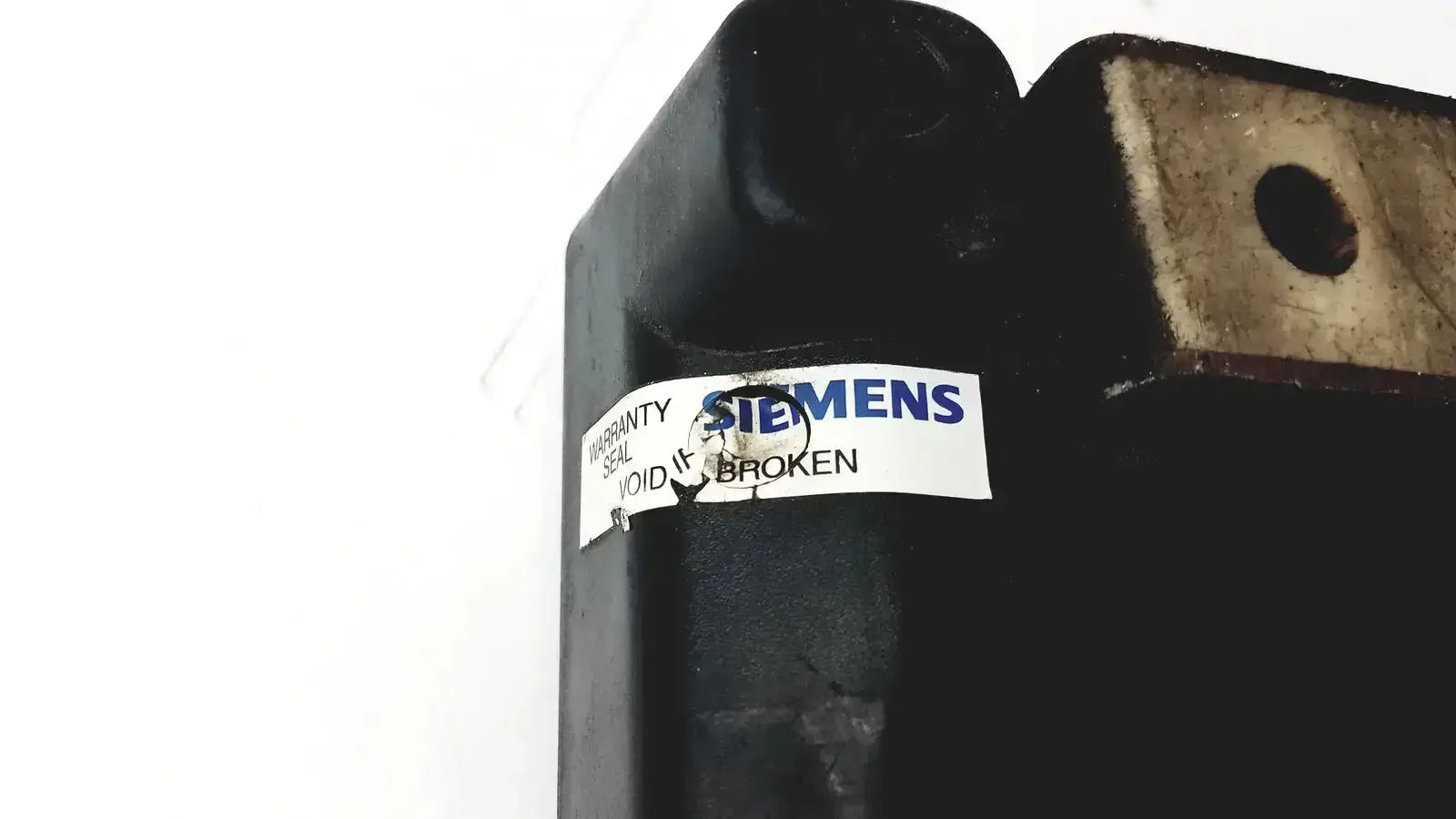 Black industrial hydraulic cylinder with torn white siemens warranty seal on siemens cincinnati milacron cnc lathe controller back side