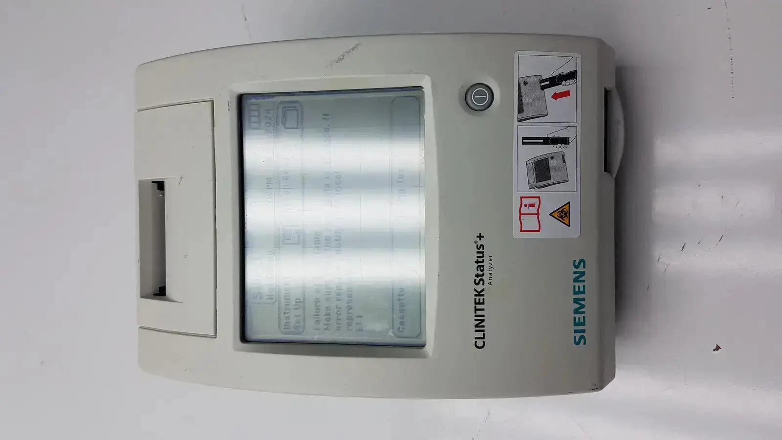Siemens clinitek status analyzer medical device with gray casing and rectangular screen displaying diagnostic information