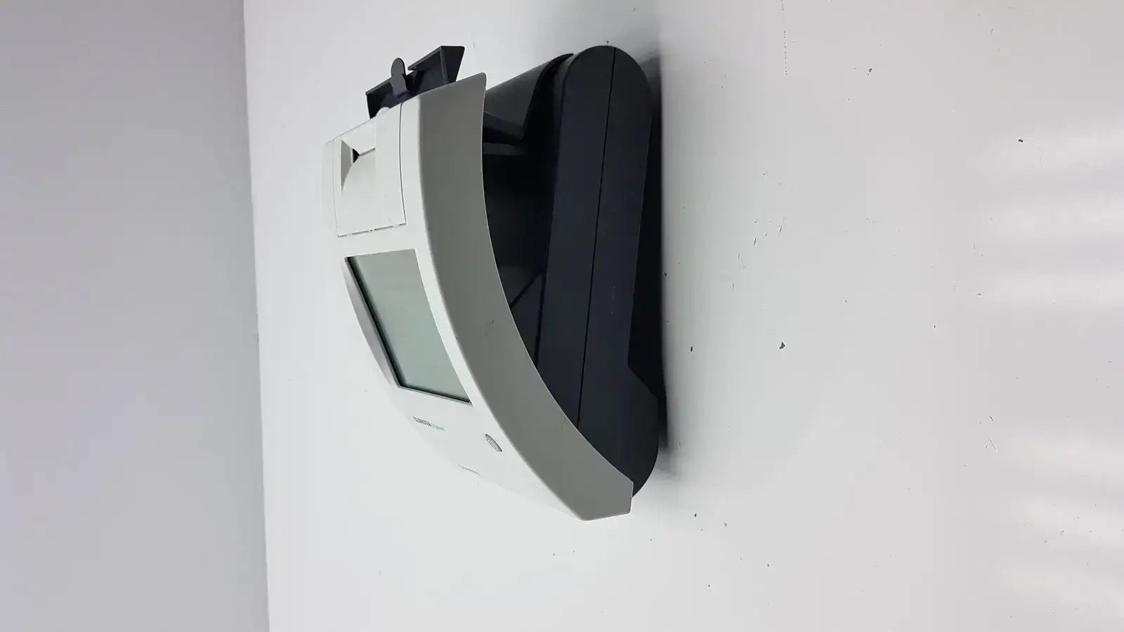 Siemens clinitek status analyzer with a curved white and black wall-mounted receipt printer for medical diagnostics