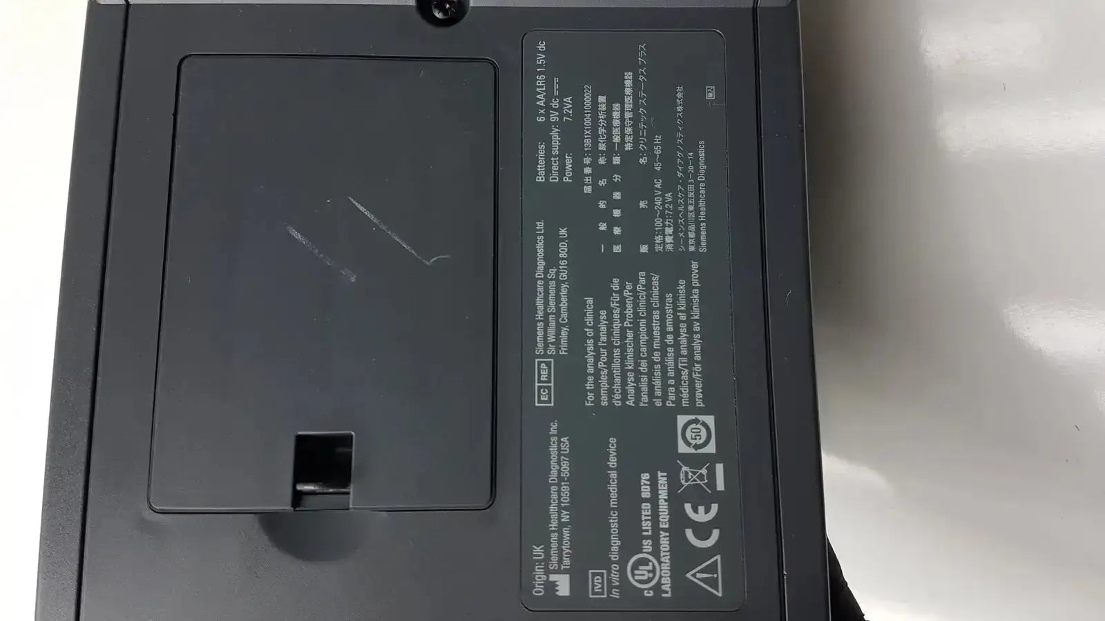 Black rectangular siemens clinitek status analyzer medical device with matte finish and labeled specifications on back panel