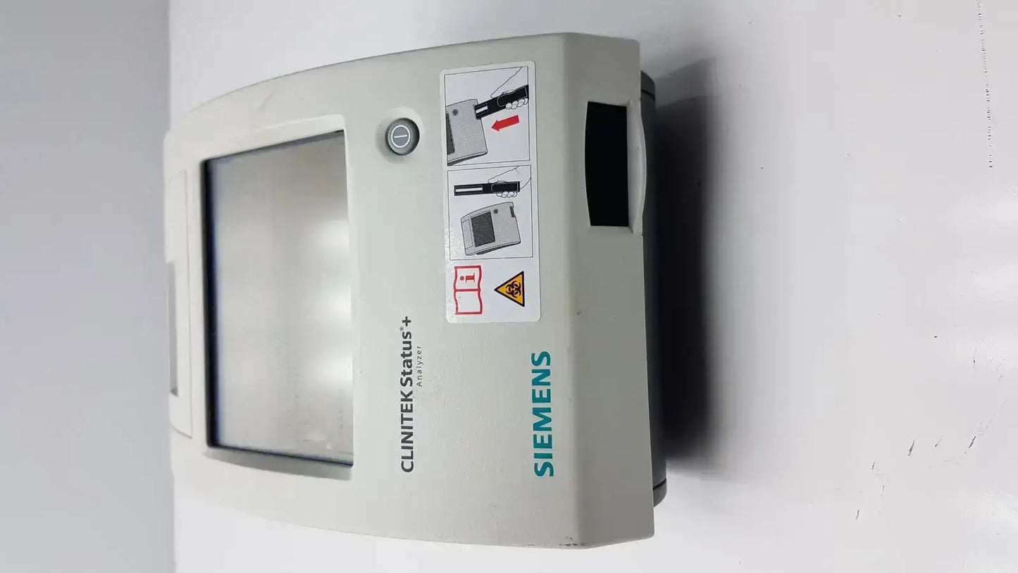 Gray Siemens Clinitek status+ medical monitor with rectangular screen and control buttons for clinical analysis