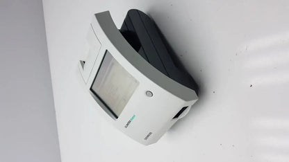 White and black Siemens motion sensor with rectangular display window on Siemens Clinitek Status Analyzer 004979 device
