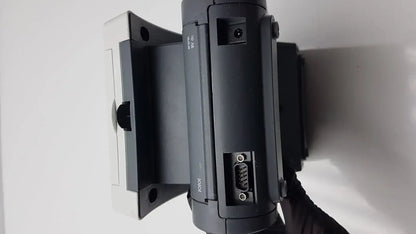 Black plastic siemens clinitek status analyzer with white mounting bracket and visible serial connector ports back view