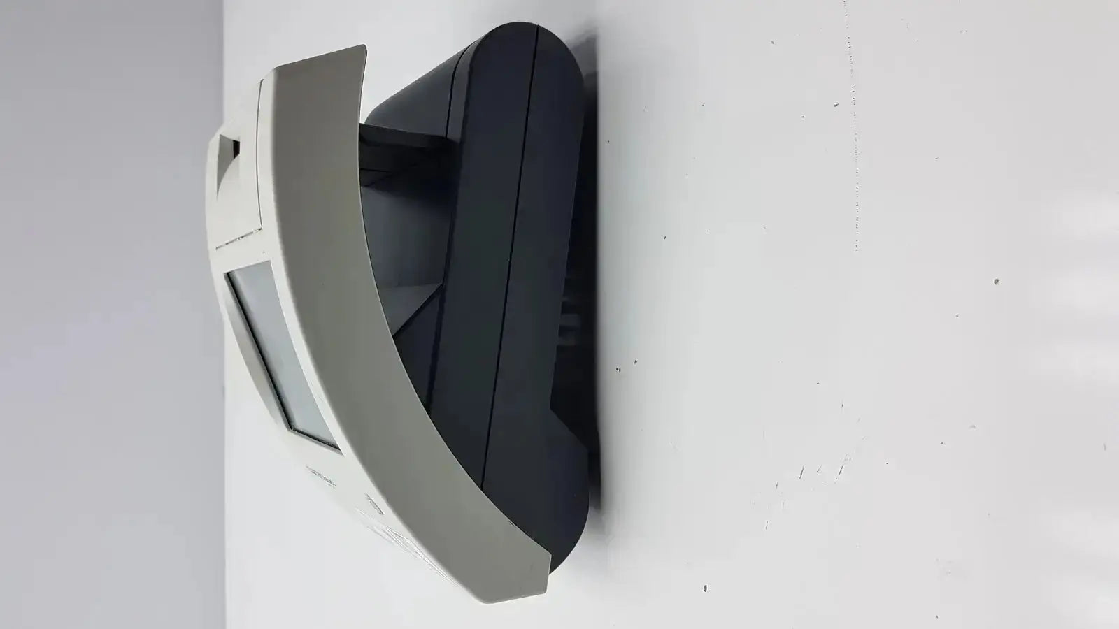 Gray and black wall-mounted atm machine with curved front panel in siemens clinitek status analyzer 004979 model