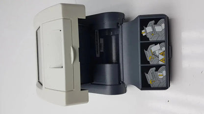 Gray plastic siemens clinitek status analyzer with hinged lid and three illustrated compartments on the right side