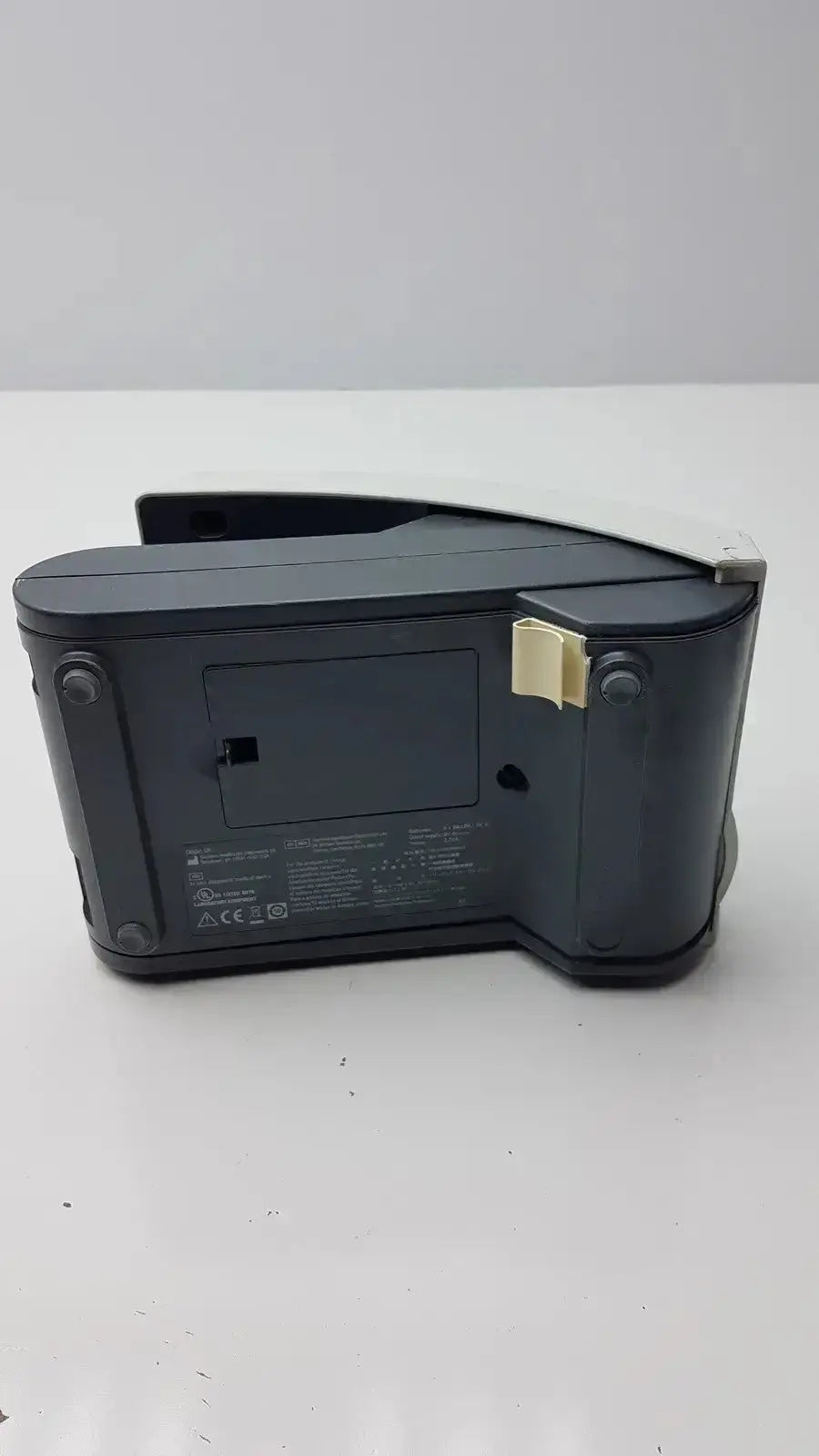 Black plastic digital clock with beige clip on the side of siemens clinitek status analyzer model 004979