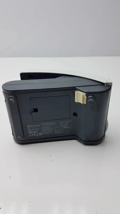 Black plastic digital clock with beige clip on the side of siemens clinitek status analyzer model 004979