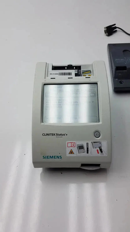 Gray Siemens Clinitek Status+ medical analyzer with rectangular screen and control buttons for clinical testing