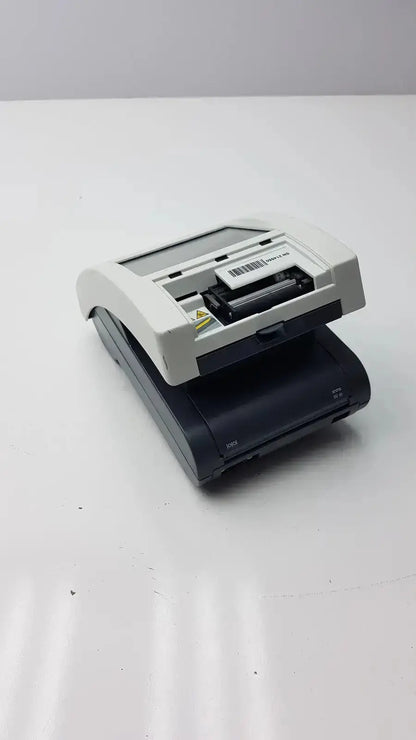 Siemens clinitek status handheld barcode scanner with black and white plastic housing and visible internal components