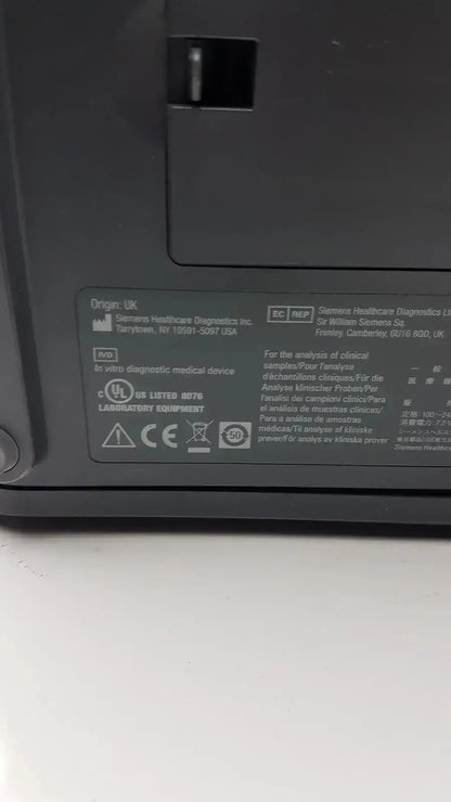 Black siemens clinitek status analyzer model 004979 with regulatory label and manufacturer information on the back panel