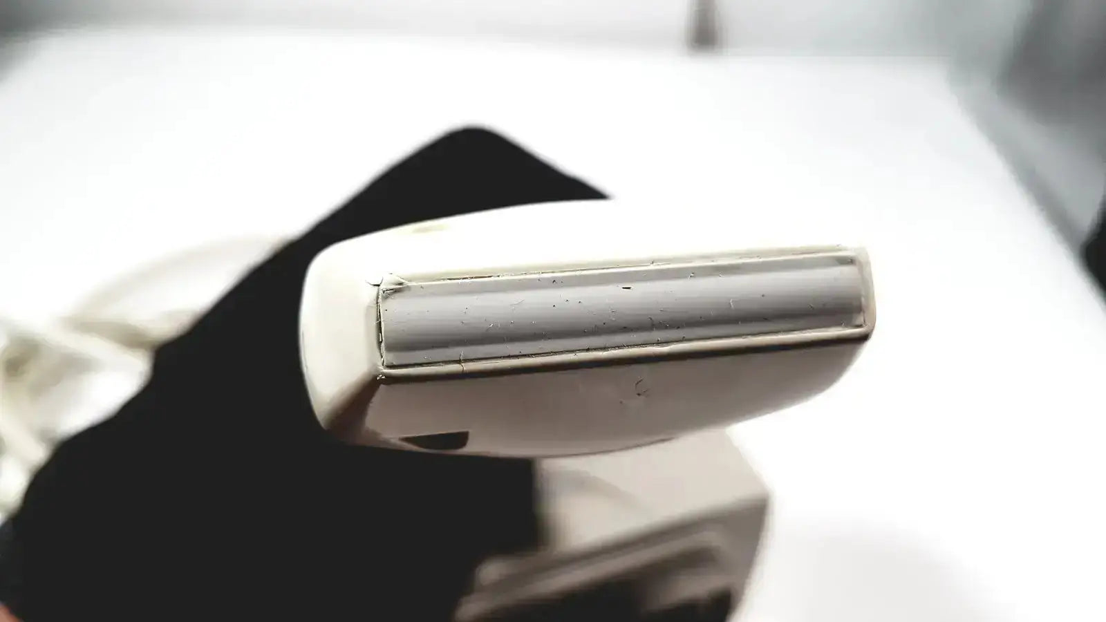 White plastic razor handle with metallic blade guard shown with siemens la435 transducer for acuson p300 ultrasound