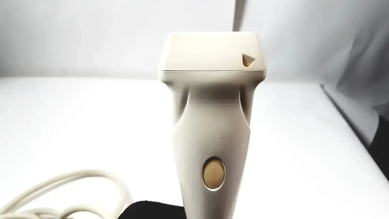 Cream-colored plastic siemens la435 transducer probe with rounded head and oval power button for acuson p300 ultrasound