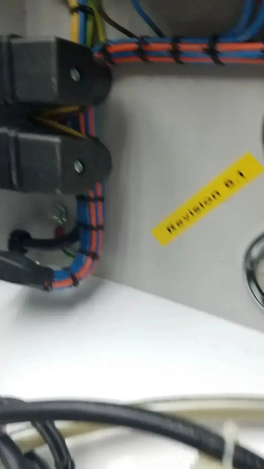 Black plastic electrical connectors with bundled red blue and yellow wires on the back of siemens logo 230rc 6ed1 052-1fb00-0ba4