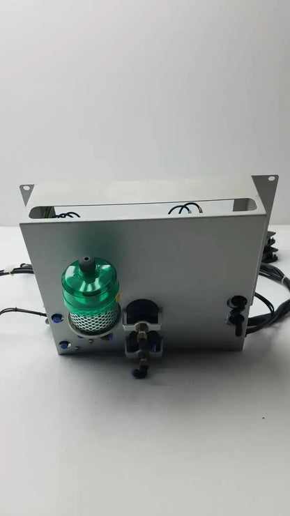 Silver metallic siemens logo 230rc 6ed1 052-1fb00-0ba4 industrial control unit with green translucent cylinder and black wiring