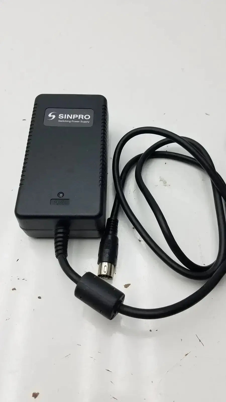 Sinpro switching power supply adapter g-bbde3-17k with black coiled cable and metallic connector for pre owned medical equipment