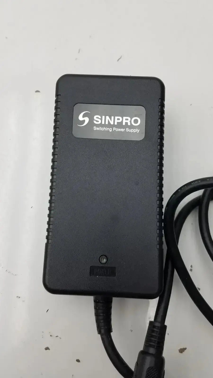 Black sinpro switching power supply adapter g-bbde3-17k with textured edges and coiled cables for pre owned medical equipment