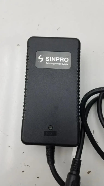 Black sinpro switching power supply adapter g-bbde3-17k with textured edges and coiled cables for pre owned medical equipment