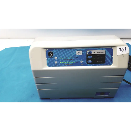 Gray medical device with a blue control panel featuring buttons and an illuminated display.