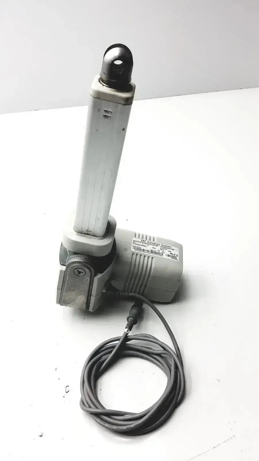 Gray skf actuation linear actuator max30-a150365ac5100-000 with cylindrical arm and coiled power cable from hospital surplus