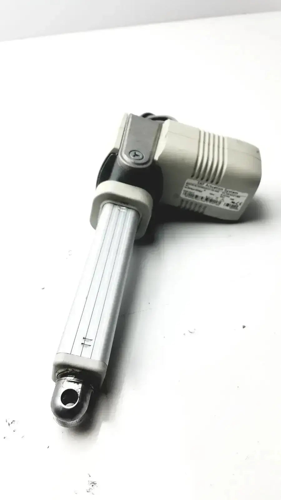 Silver and gray linear actuator with ribbed cylindrical shaft and compact motor housing from skf actuation hospital surplus