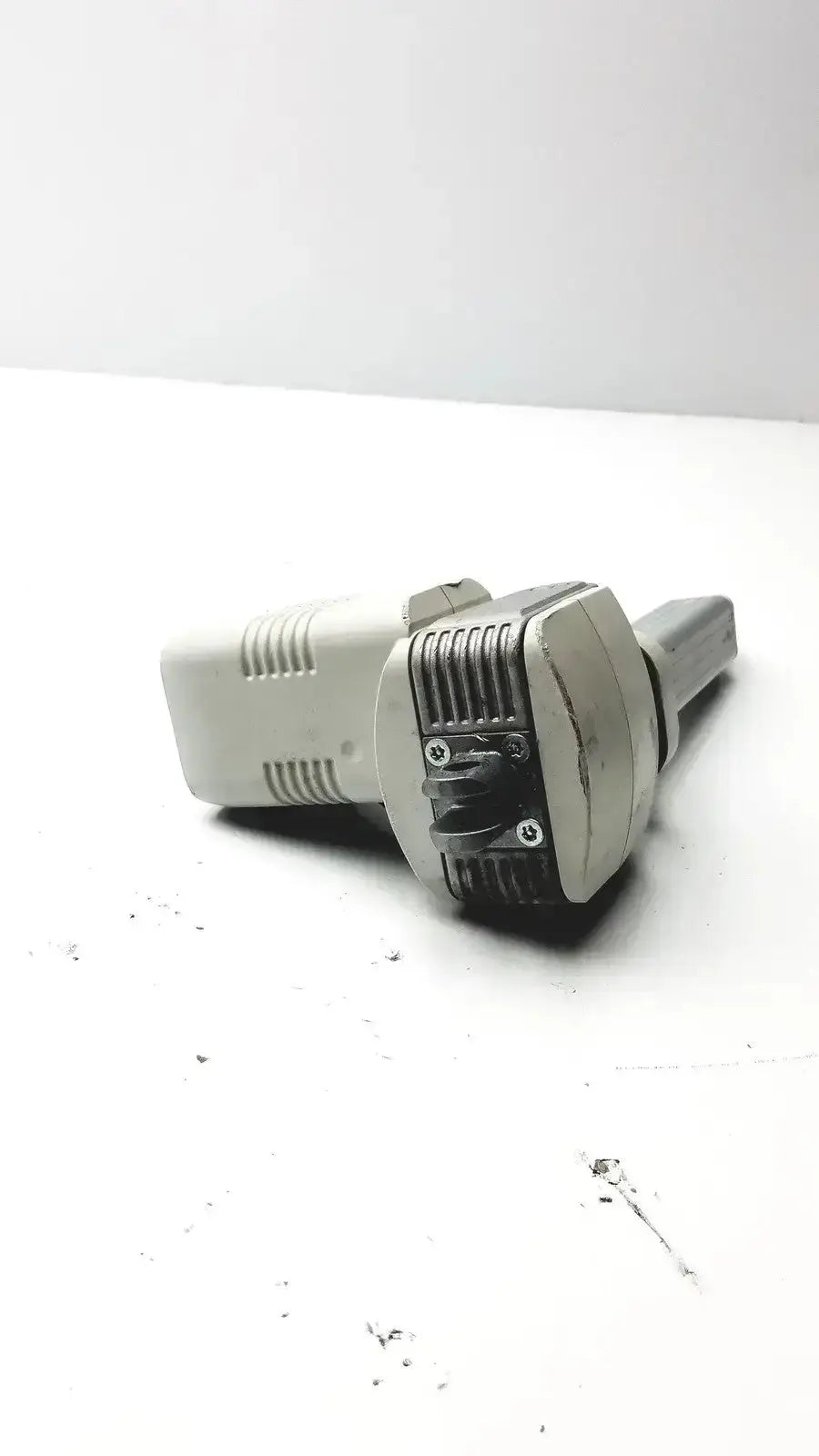 Gray and black plastic power adapter with ribbed connector end for skf actuation linear actuator hospital surplus use