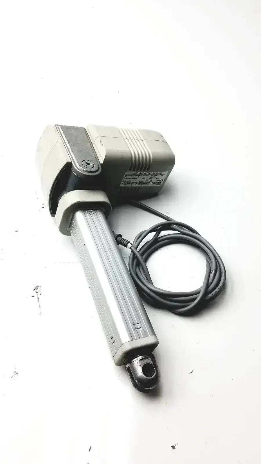 Silver and gray skf actuation linear actuator with coiled black power cable for hospital surplus use
