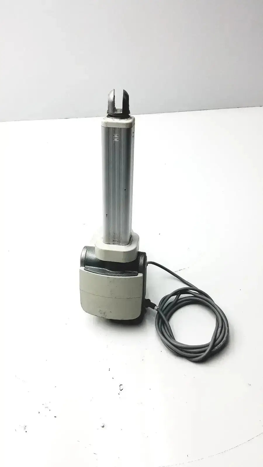 Silver and gray skf actuation linear actuator with coiled black cable hospital surplus electric motor detail