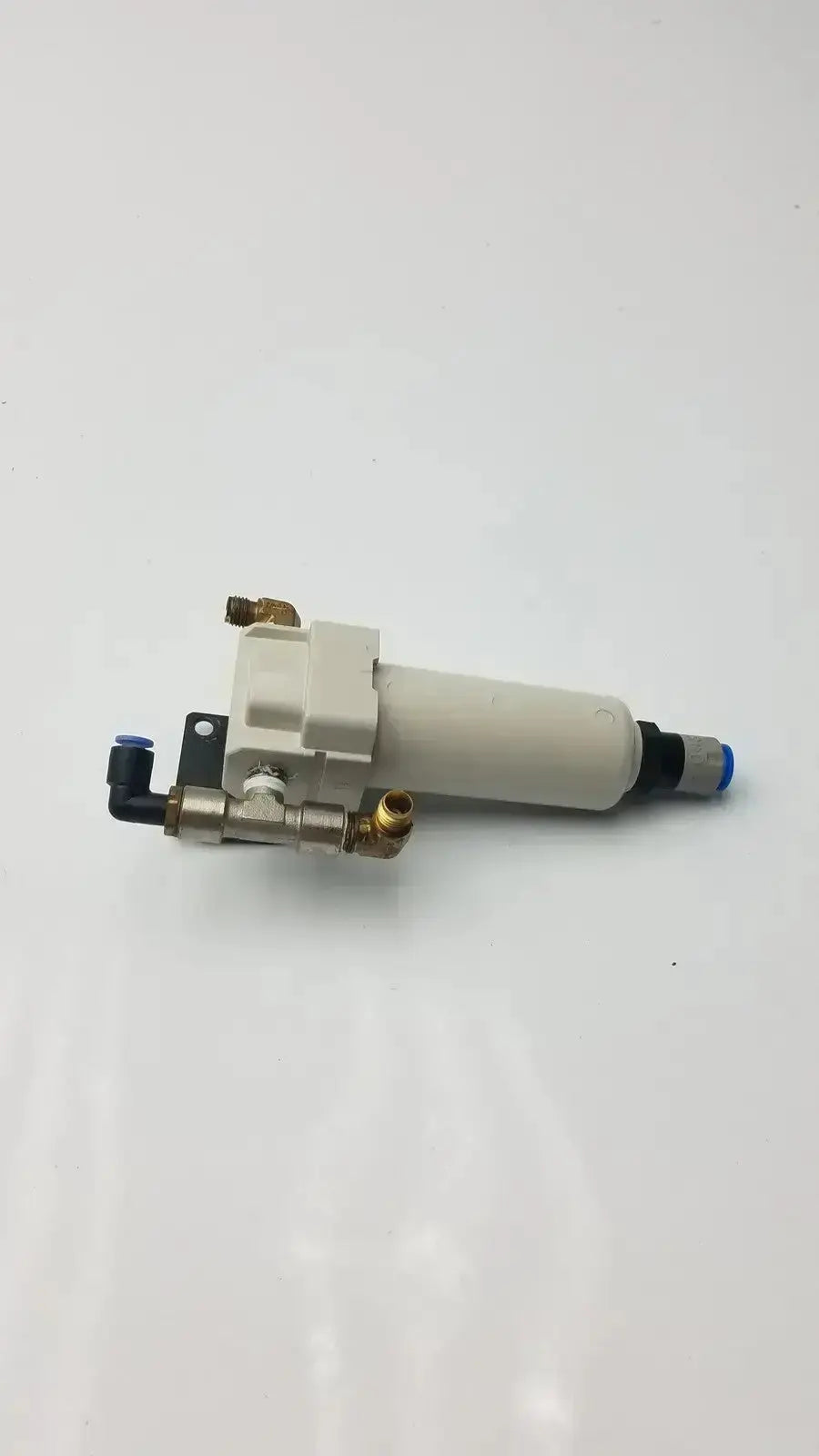 White cylindrical smc fd30-n02c-2z-a air filter with brass fittings and black connectors rated at 150 psi max pressure