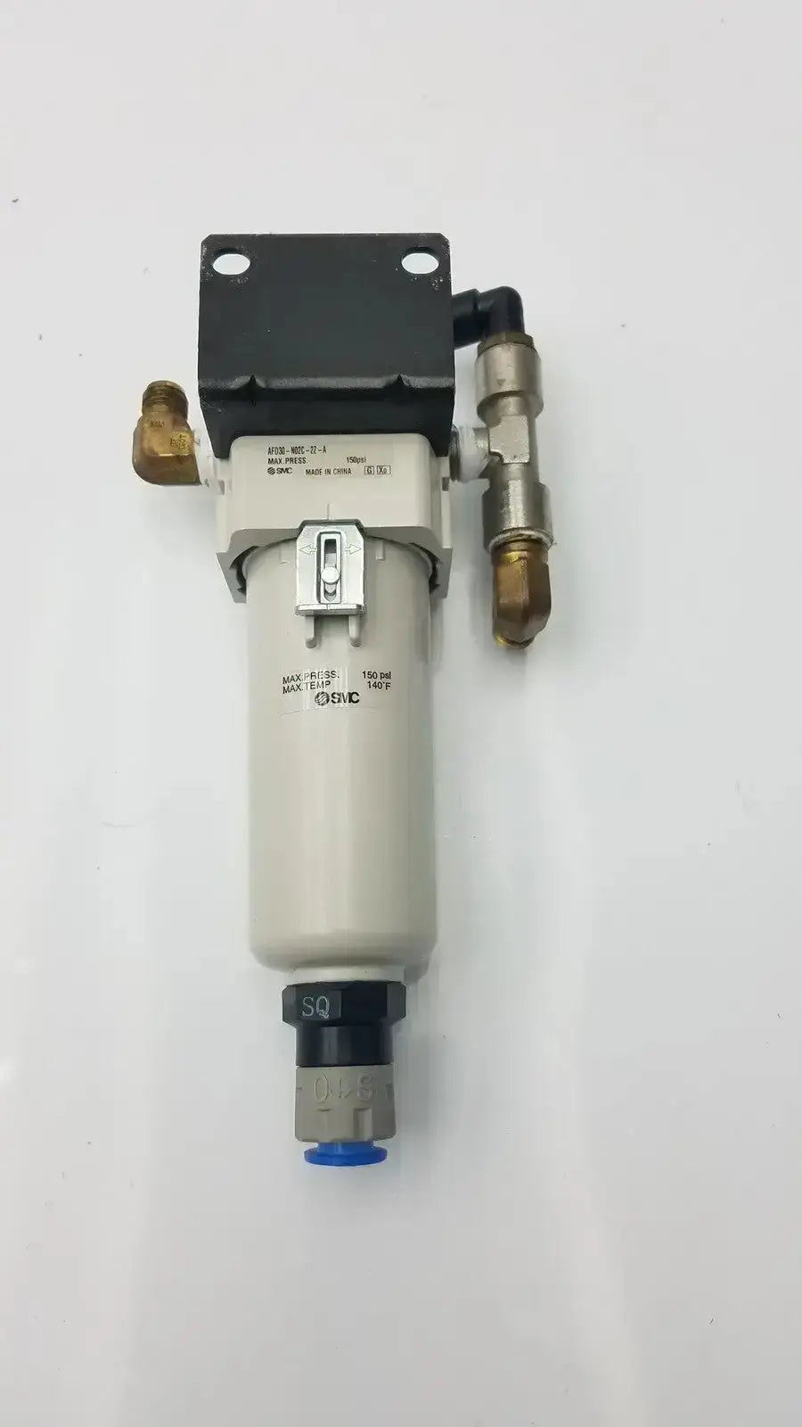 Gray cylindrical smc fd30-n02c-2z-a air filter with black top plate brass fittings and silver toggle switch rated for 150 psi max pressure