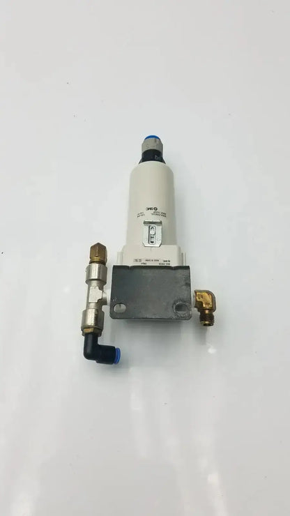 Smc fd30-n02c-2z-a white cylindrical air filter with brass fittings and blue cap rated for 150 psi max pressure mounted on gray base