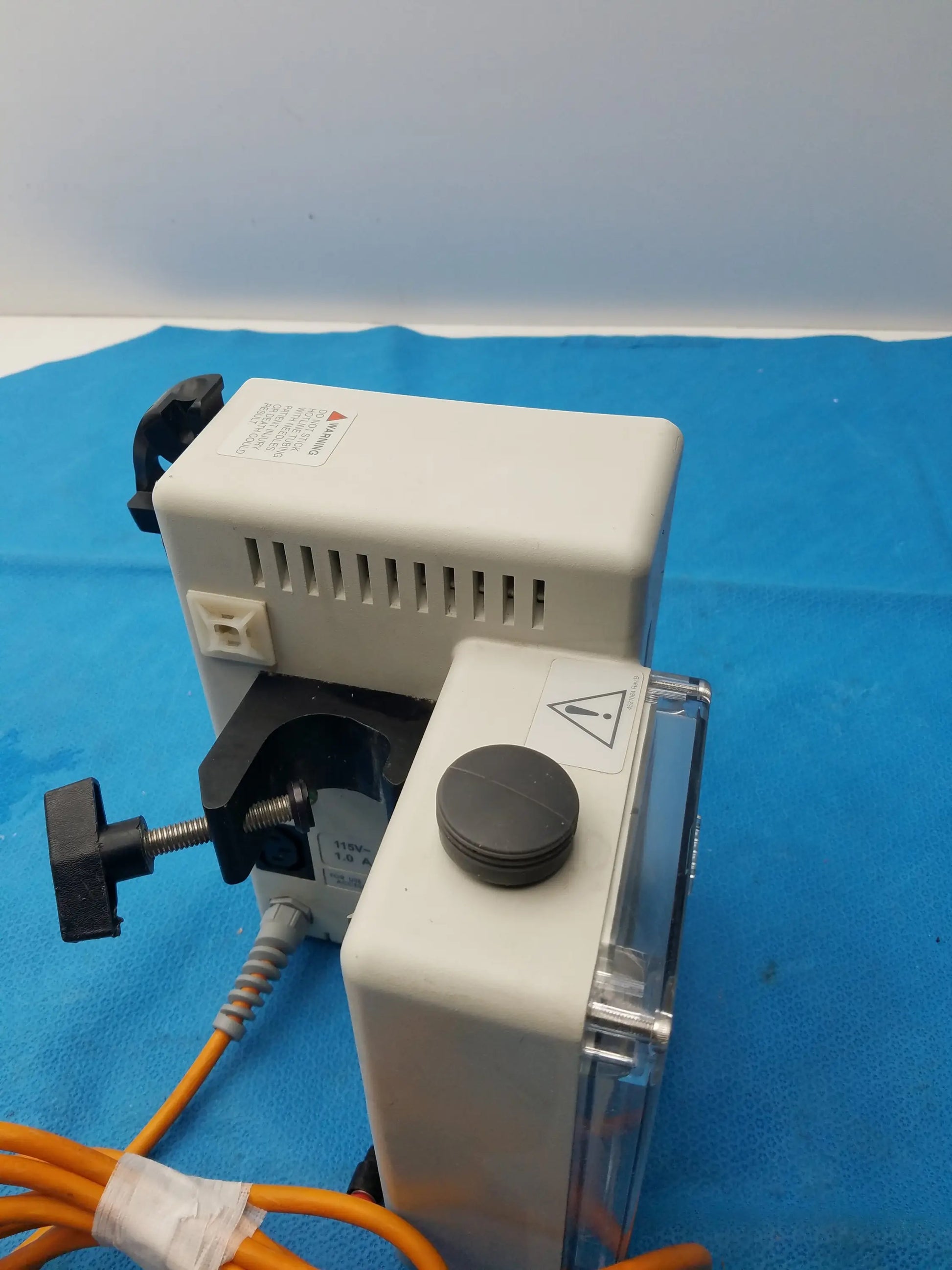 White plastic smiths medical fluid warmer control box unit with black clamp and orange cables for medical equipment use