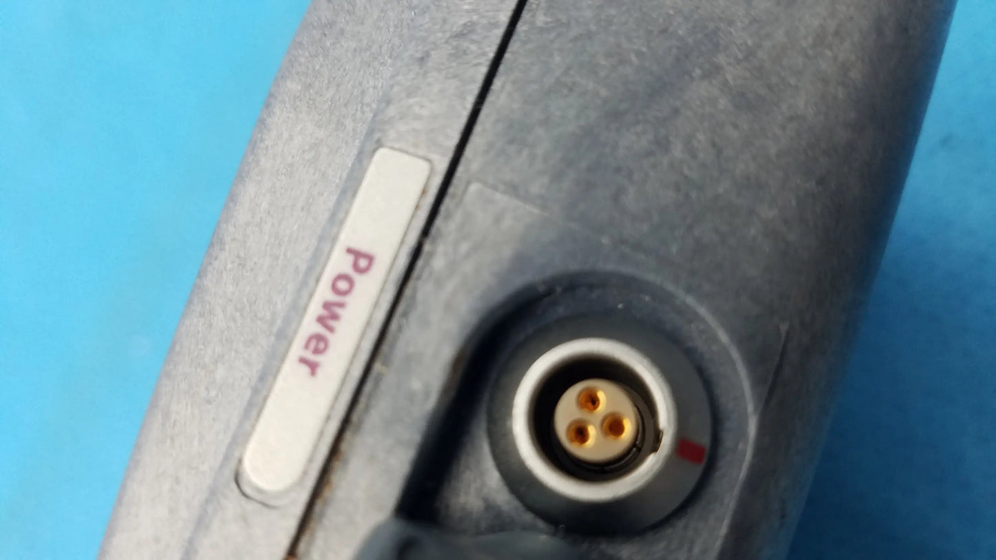 Gray metallic power adapter with white power button and gold three-pronged connector for smiths medical infusion pump medical equipment