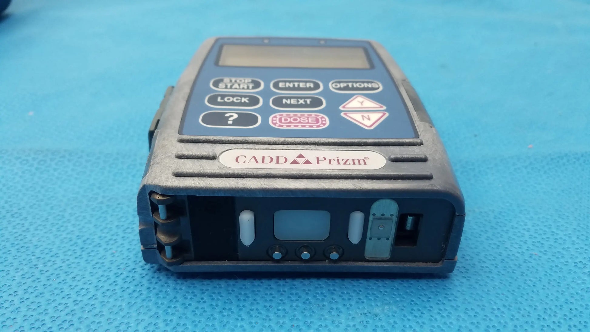 Black cadd prizm handheld radiation dosimeter with digital display and buttons used in medical equipment applications
