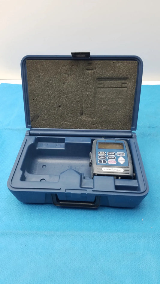 Blue plastic case containing gray smiths medical cadd prizm infusion pump with buttons and digital screen