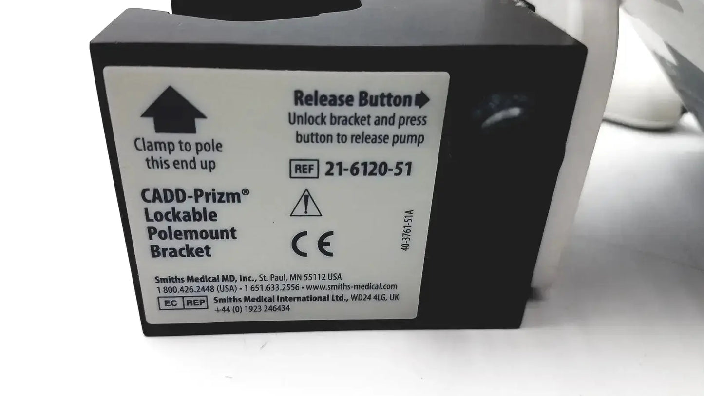 Black lockable polemount bracket with white label showing release instructions on smiths medical cadd-solis 2110 back side