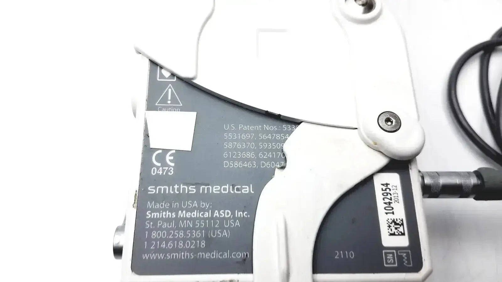 White plastic smiths medical cadd-solis 2110 medical device with black label showing smiths medical branding and patent info
