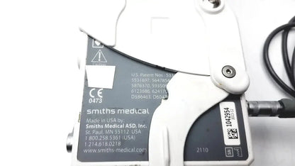 White plastic smiths medical cadd-solis 2110 medical device with black label showing smiths medical branding and patent info