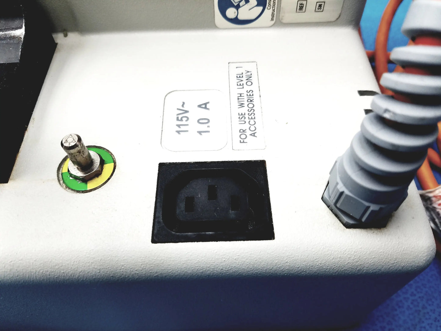 White plastic power outlet with black insert and green-yellow reset button on smiths medical hl-390 fluid warmer