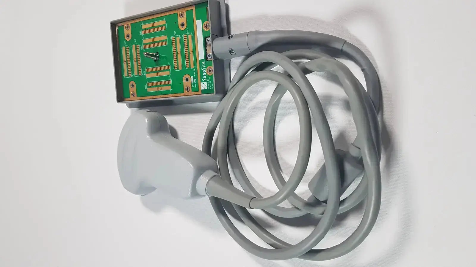 Gray sonosite c60x mhz ultrasound transducer with coiled cable and green circuit board housing p07680-21 back view