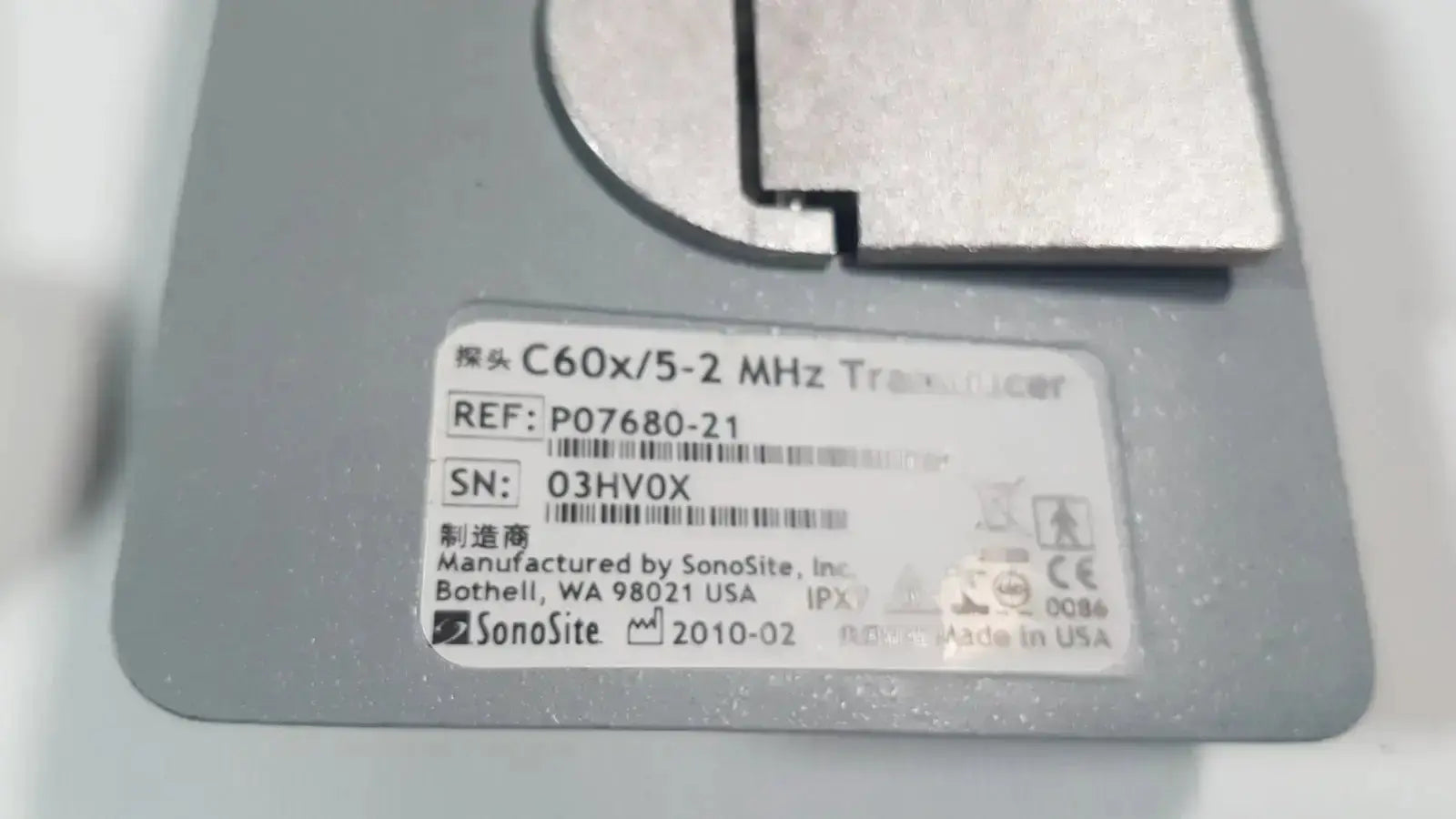 Gray rectangular SonoSite C60x 5-2 MHz ultrasound transducer probe with metallic component and label p07680-21 visible