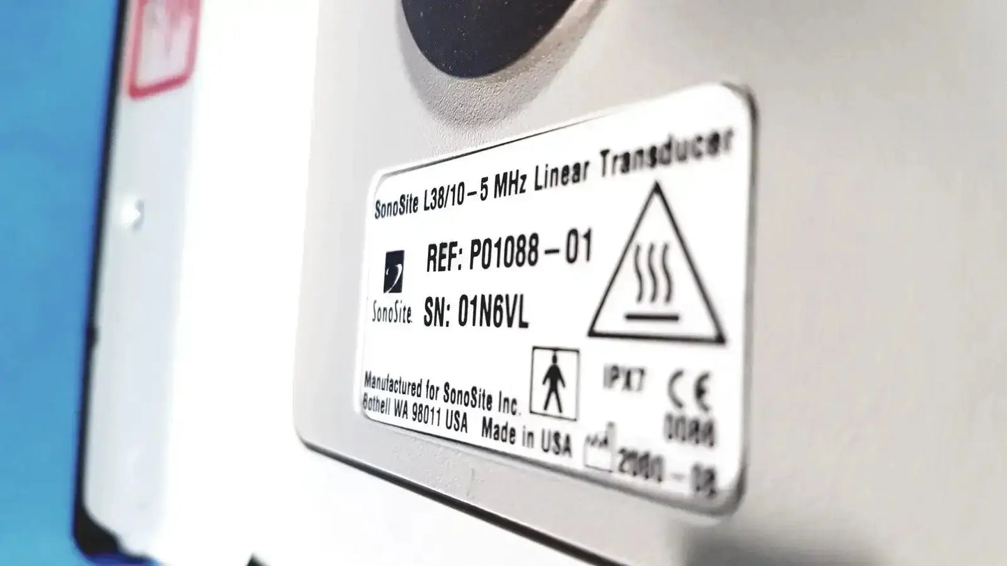 White rectangular label with black text showing sonosite l38 mhz linear transducer model on rolling stand base