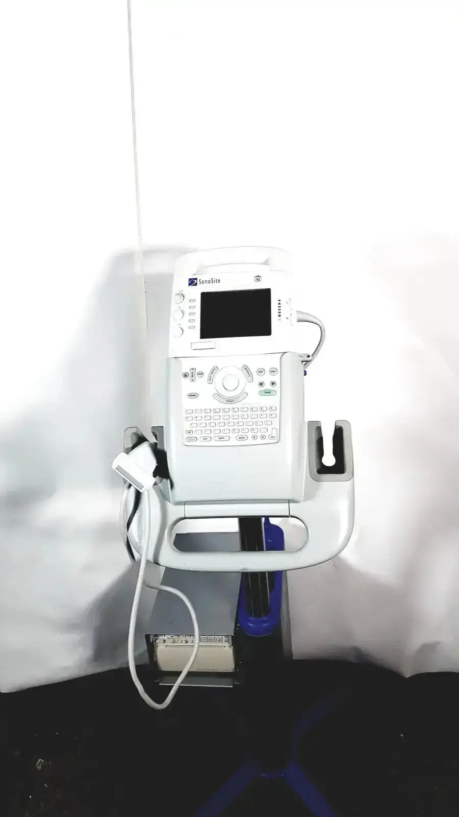 White medical ultrasound machine with sonosite l38 mhz linear transducer and digital screen on wall-mounted stand