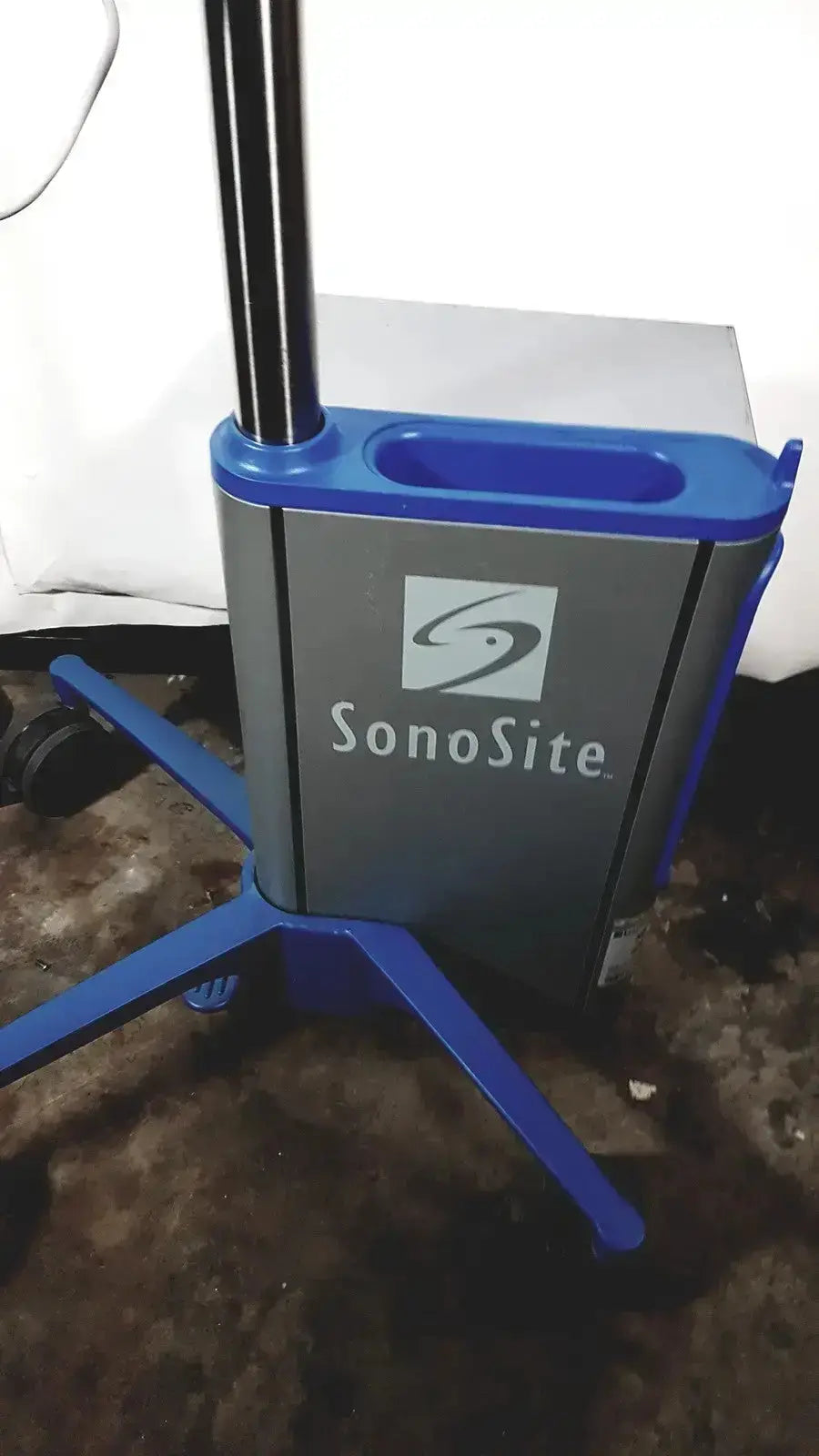 Blue and gray sonosite l38 mhz linear transducer with p01088-01 reference on a rolling ultrasound machine stand with handle